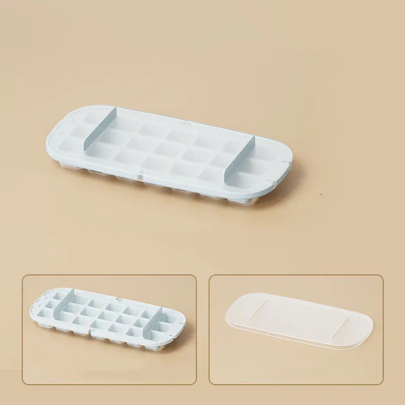 Yellow lever-action ice cube tray with high-capacity grid and attached ice shovel on a blue background.