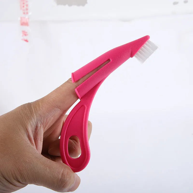 Red and white finger sleeve pet toothbrush with silicone bristles for cleaning dog and cat teeth.