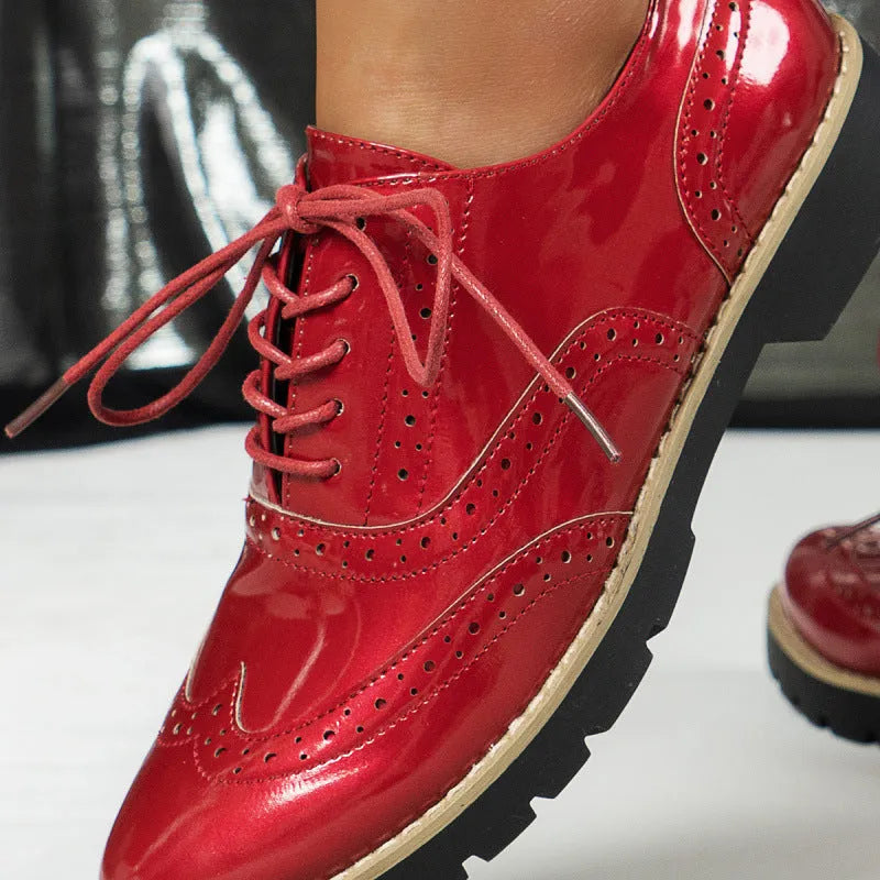 Women's black oxford shoes with wedge heel and sequin detailing, showing round toe and middle mouth cut