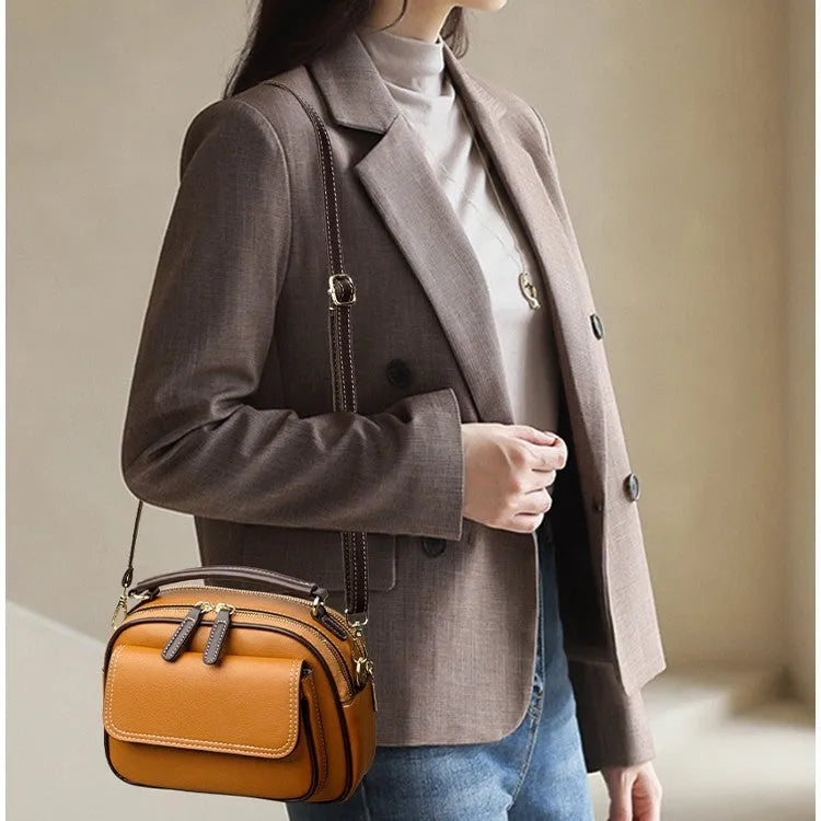 Black women's cross-body PU shoulder bag with adjustable straps showing its square shape and size.