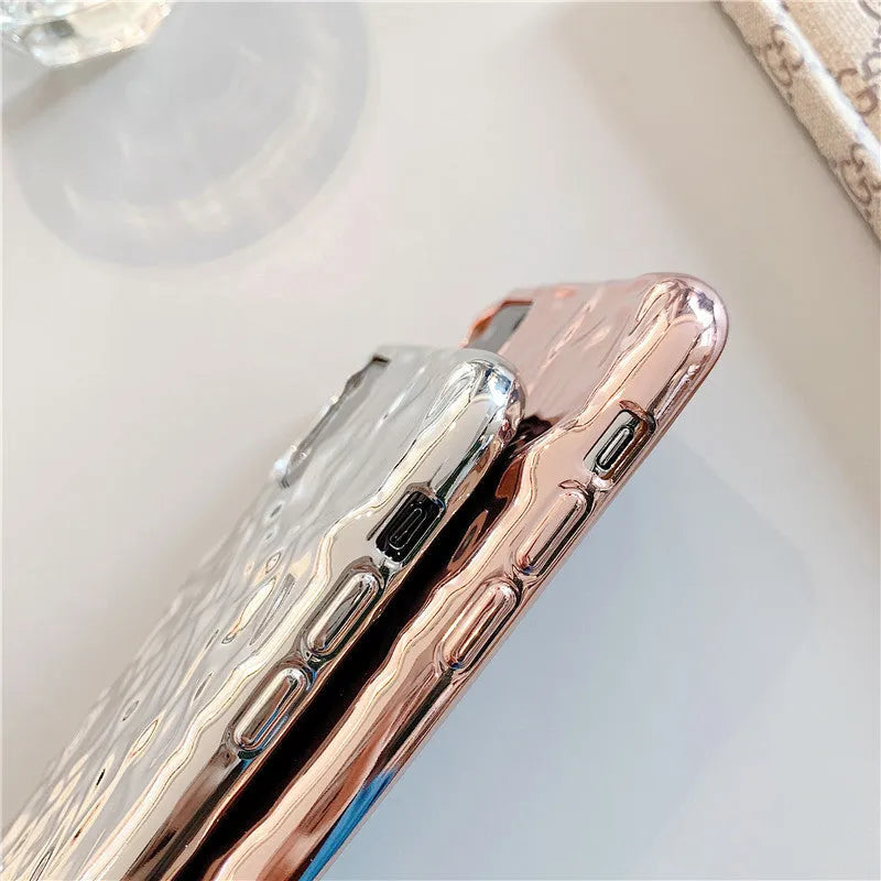 Rose gold and silver folded TPU back cover cases for various iPhone models on a plain surface.