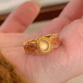 Geometric open-mouth ring with pink crystal enamel decoration on gold-plated copper band