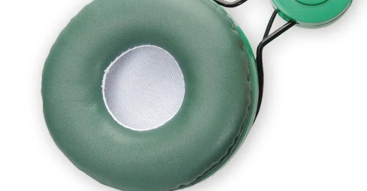 Green dinosaur children's headset with soft earmuffs and 3.5mm plug on a plain background
