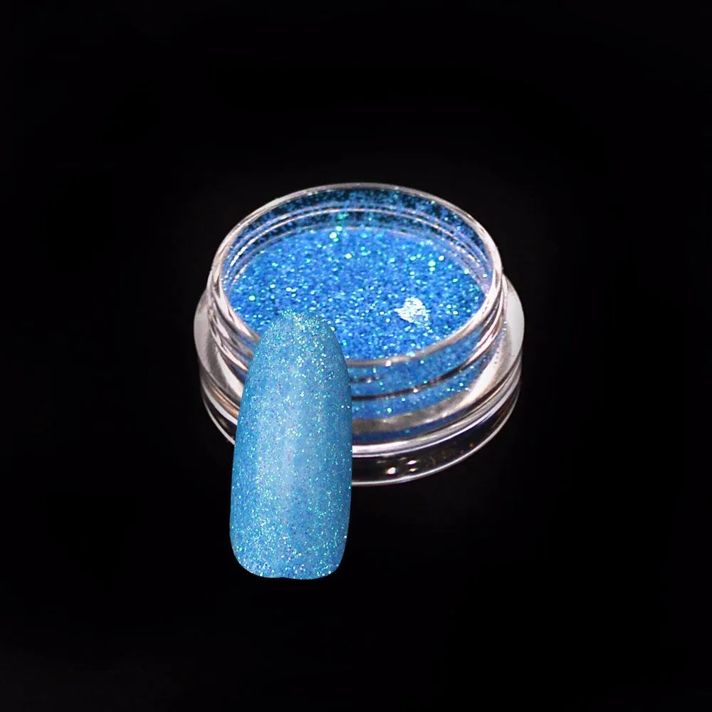 Six 1g pots of neon nail glitter powder in blue, green, orange, pink, purple, and yellow colours on a white background