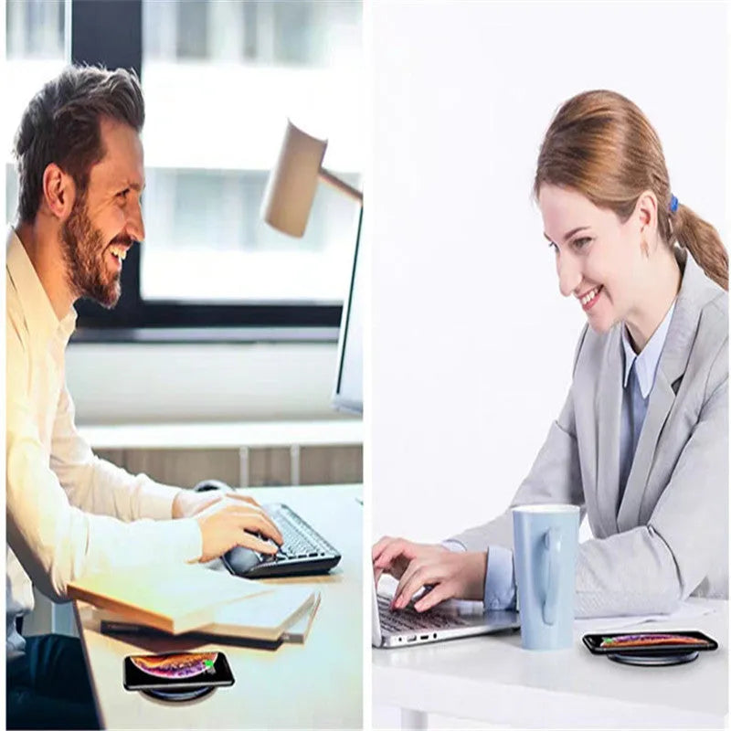 Black Qi wireless charging pad on a desk with blue LED light indicating active charging.