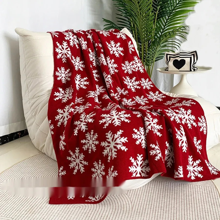 Christmas acrylic blanket with snowflake pattern in 110x130cm size on sofa