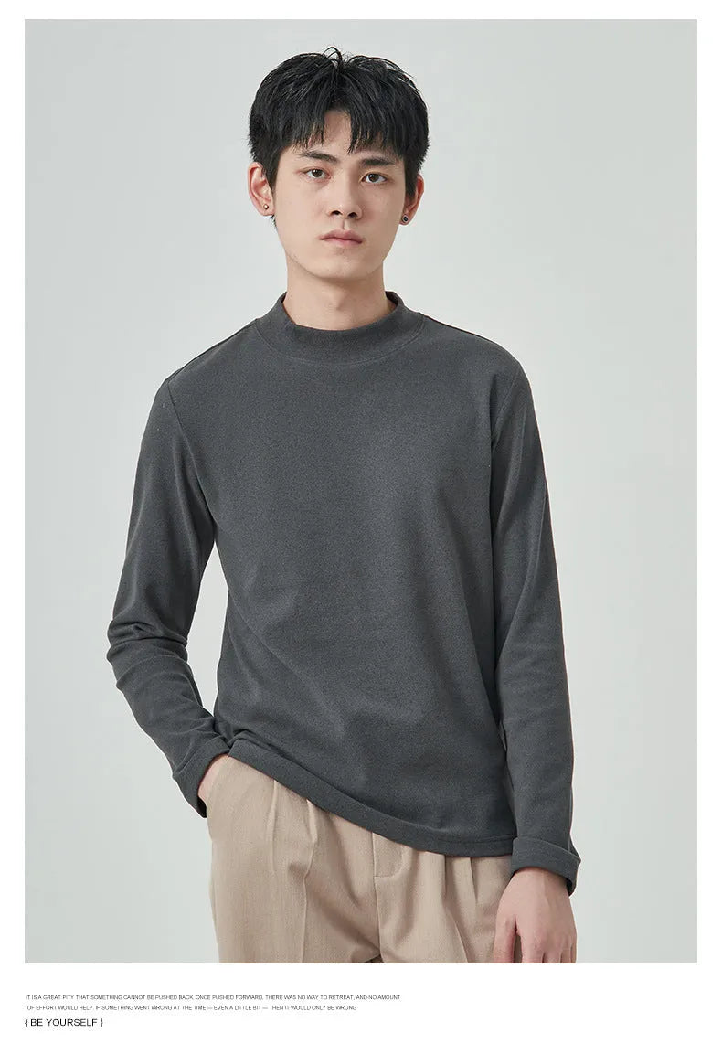 Men's brown Dralon fabric long sleeve t-shirt with a half-high collar on a hanger.