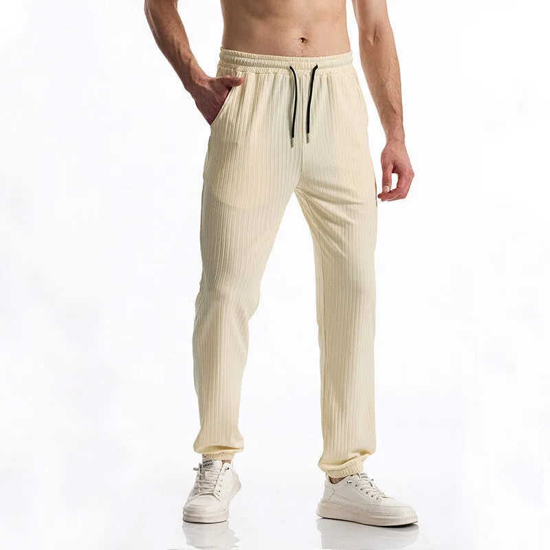Men's black silky rib fabric casual trousers with baggy straight leg and elastic waistband