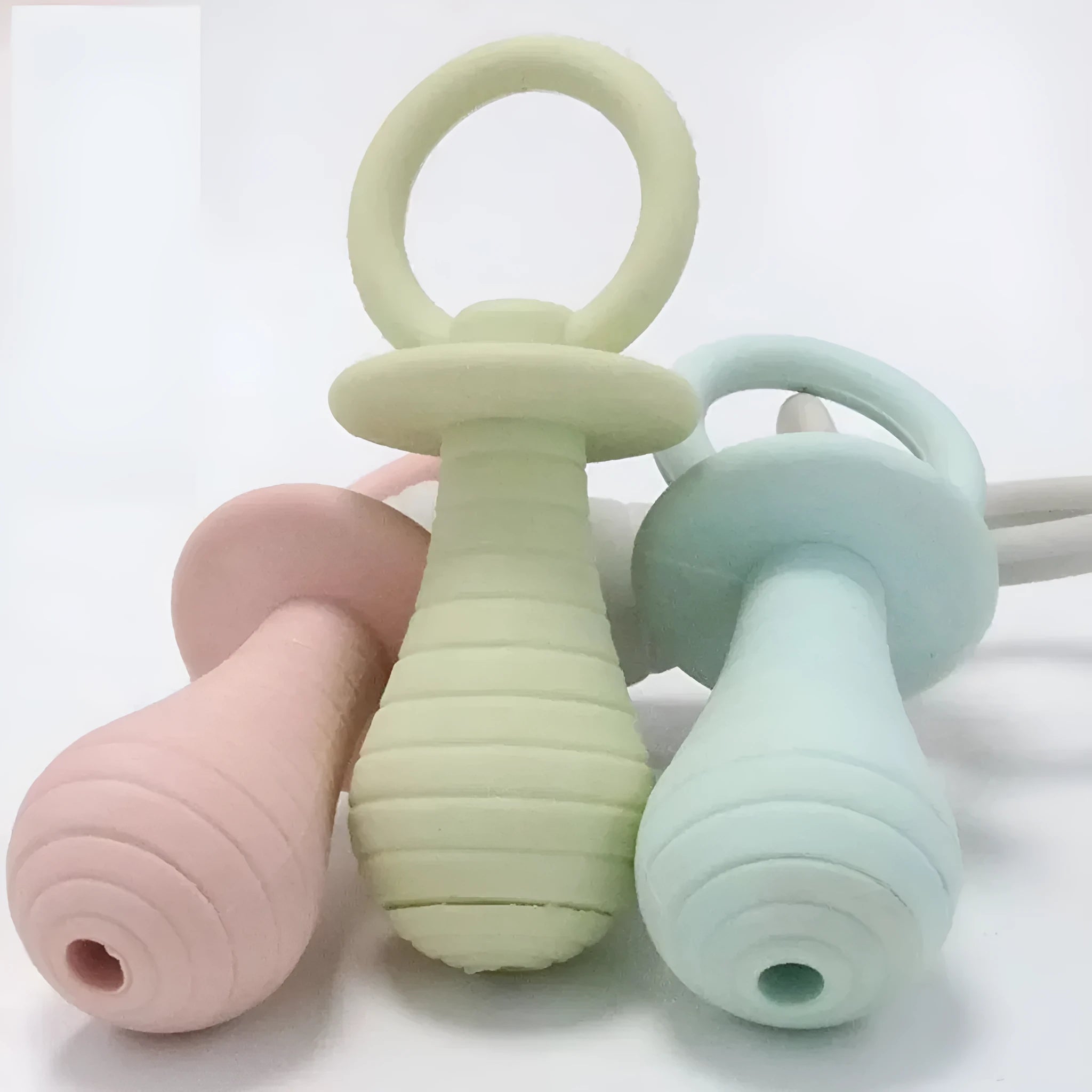 Four coloured pet pacifier rubber chew toys with squeakers for puppies and kittens