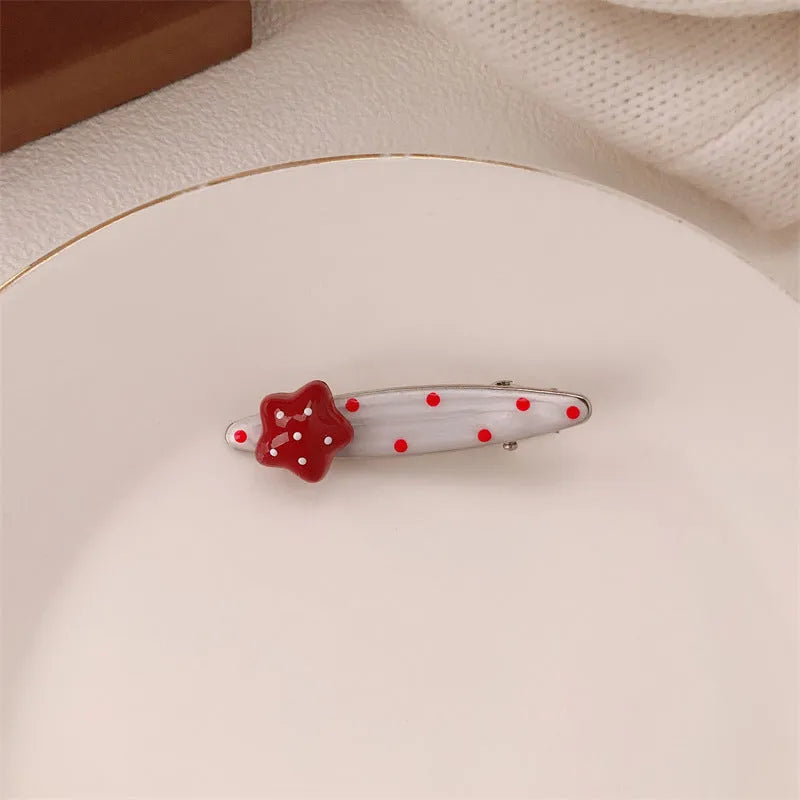 Red love heart-shaped plastic hair clip with retro dots and a willow leaf silhouette on a white background.