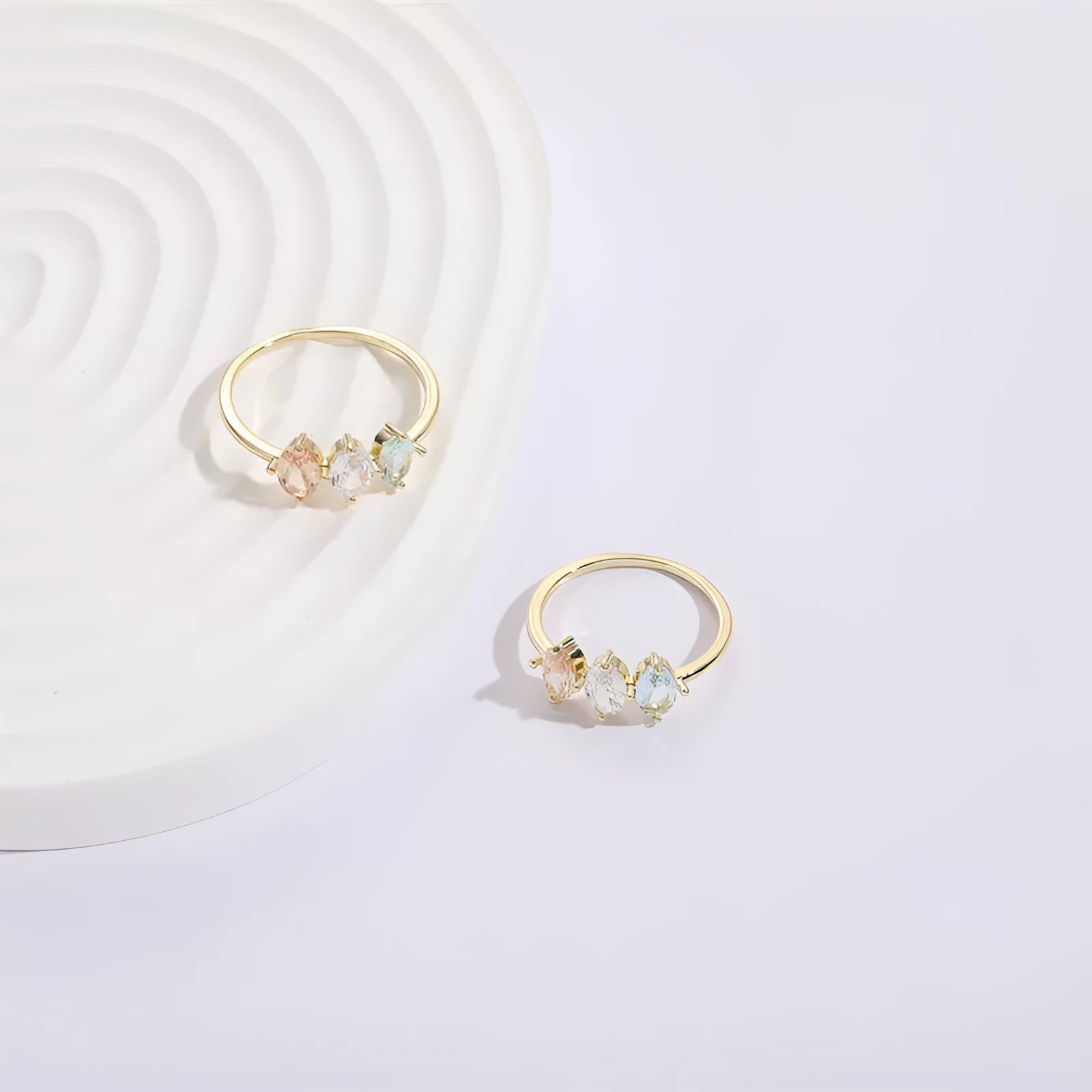 Geometric gold-colour women's ring with a triangular horse eye tricolour zircon stone.