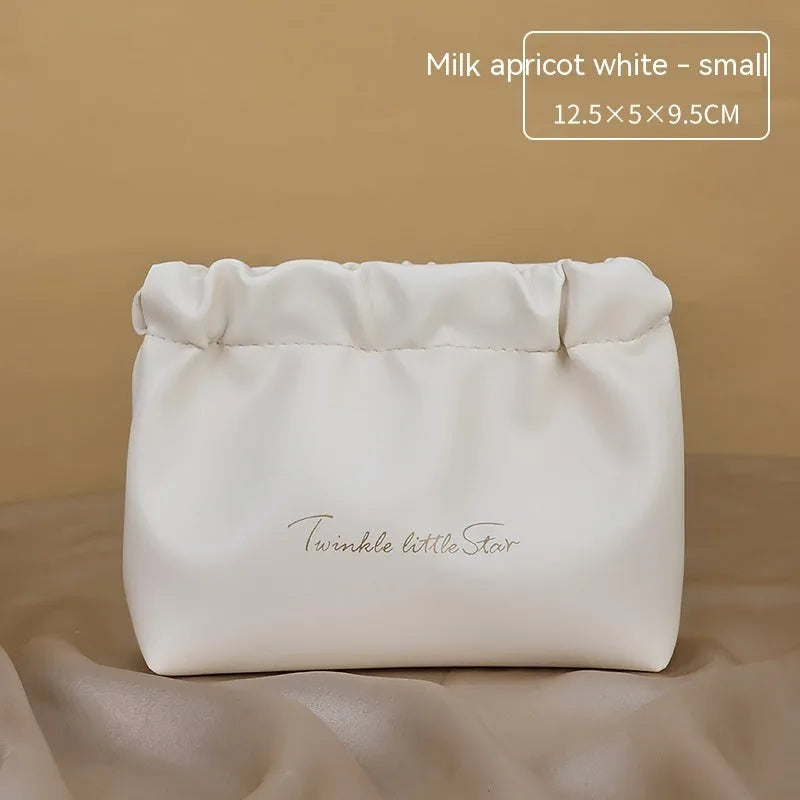 PU leather travel toiletry bag in classic black colour, showing large capacity and zipped compartments.
