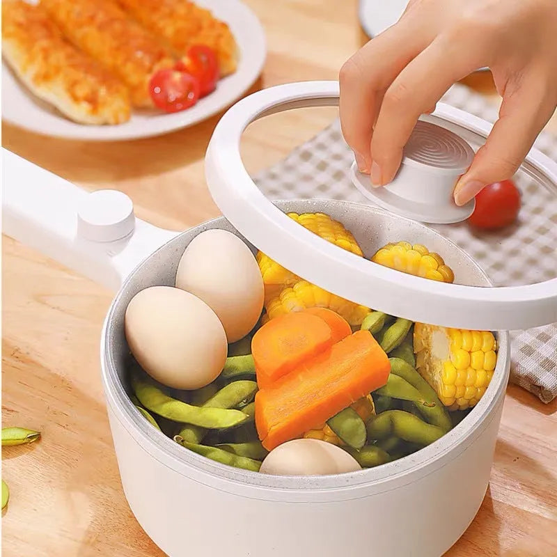 White and green multi-function electric cooking pot with control panel, 600W power, and compact design.