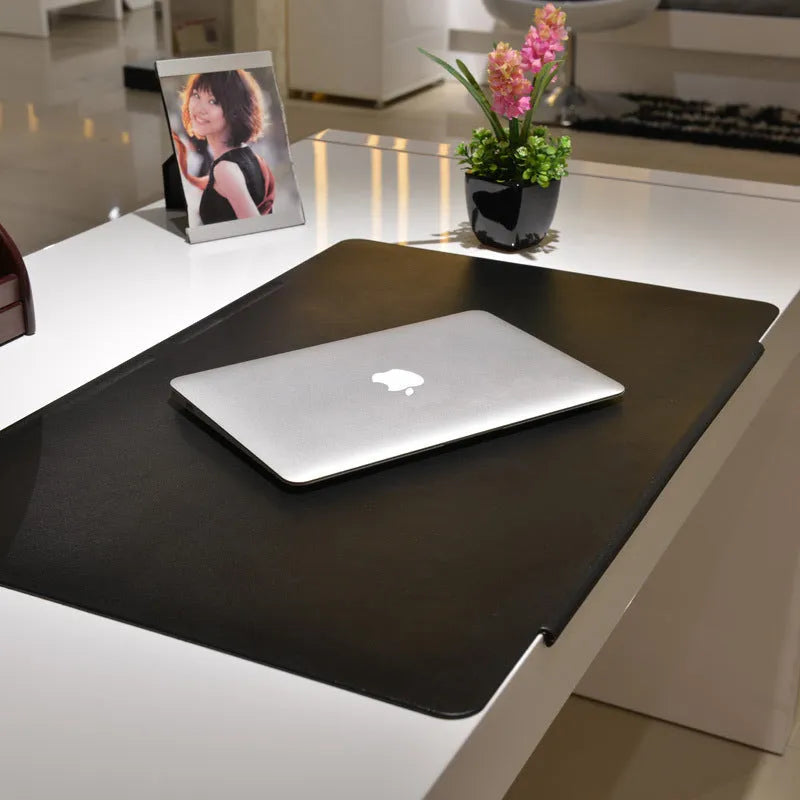 Black PVC non-slip computer desk mat 700x450x3mm on a desk with keyboard and mouse
