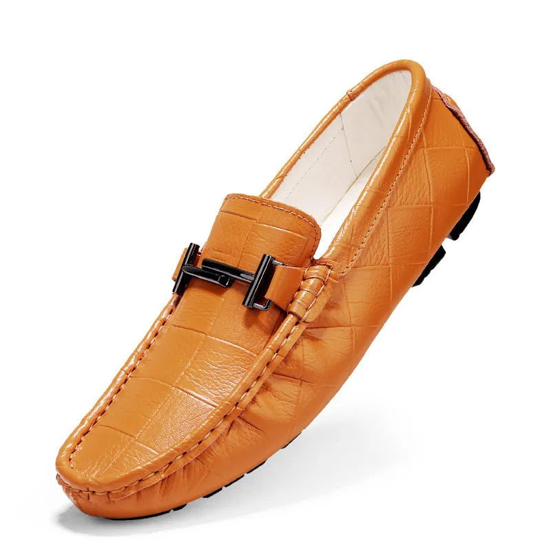 Men's black leather casual shoes with a silver belt buckle closure on a flat rubber sole.