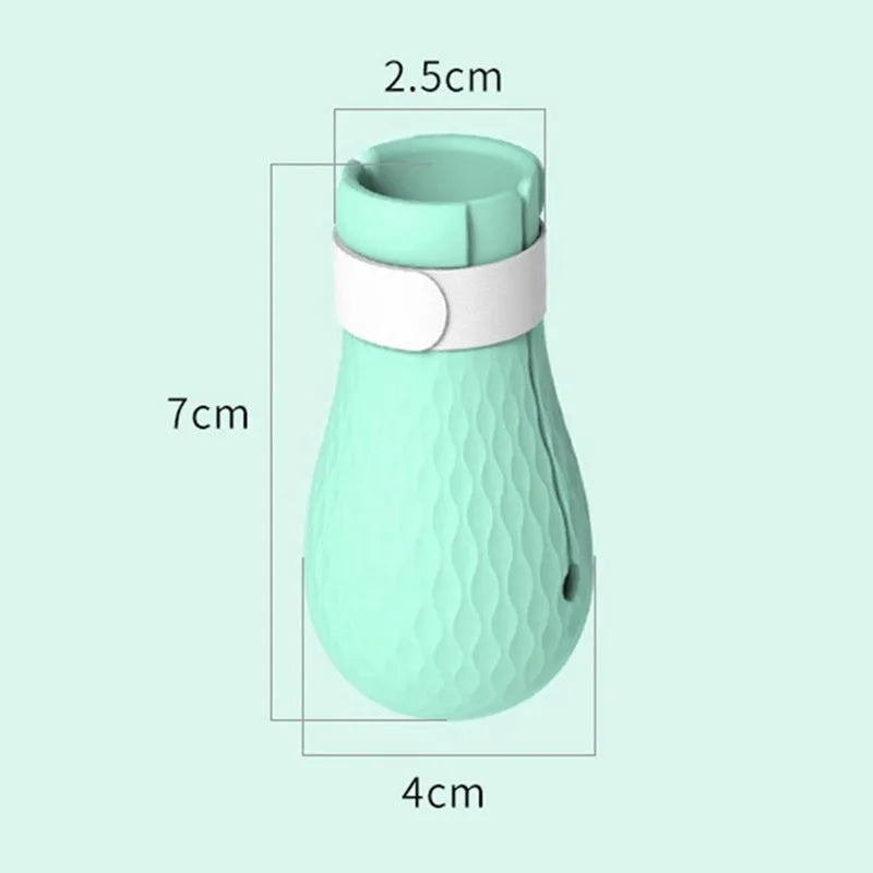 Green silicone cat bathing feet washing set with nylon buckle strap on a surface