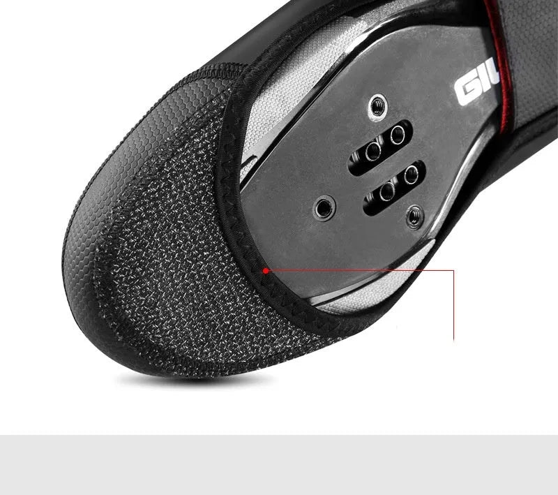 Giyo black cycling waterproof shoe covers with Kevlar and PU construction on a road bike