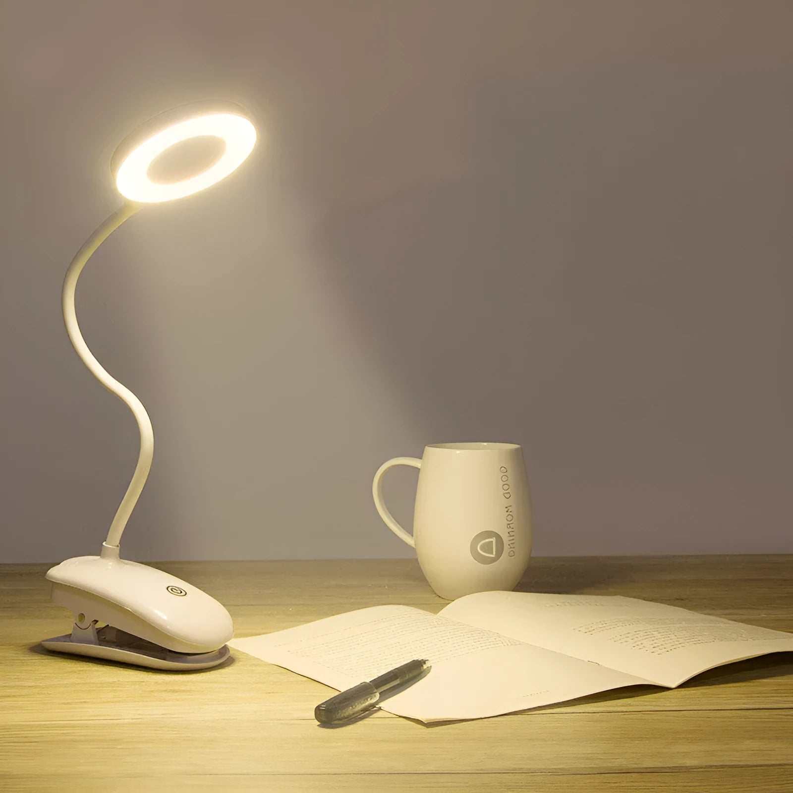 Modern clip-on rechargeable desk lamp with a white plastic shade and touch controls on its base.