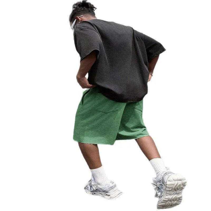 Men's straight leg polyester trousers in black, shown in a streetwear style pose.