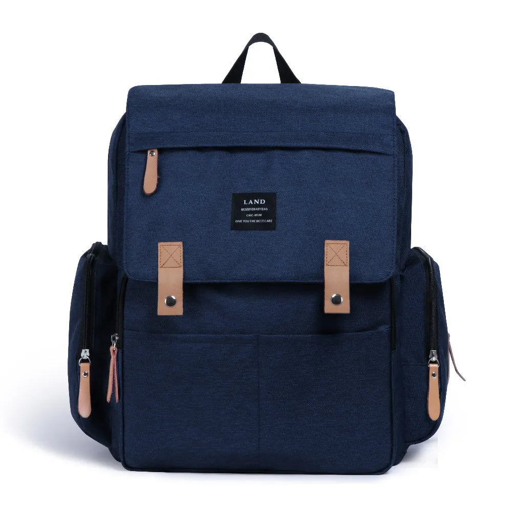 Land Mommy large oxford cloth diaper backpack in grey with a changing mat, shown open.