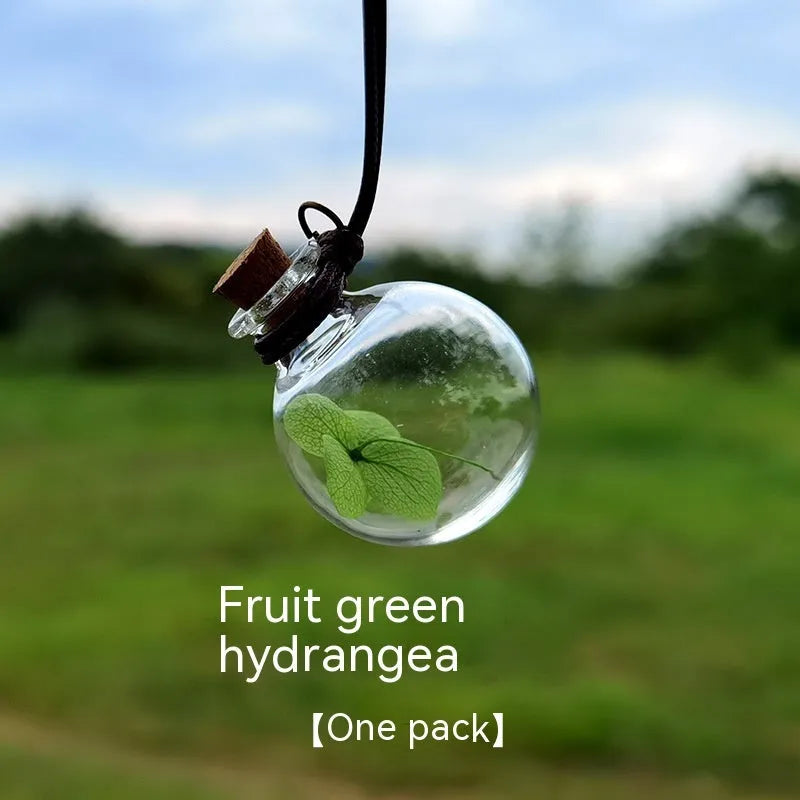 Glass car perfume pendant with preserved flower decoration hanging in car interior