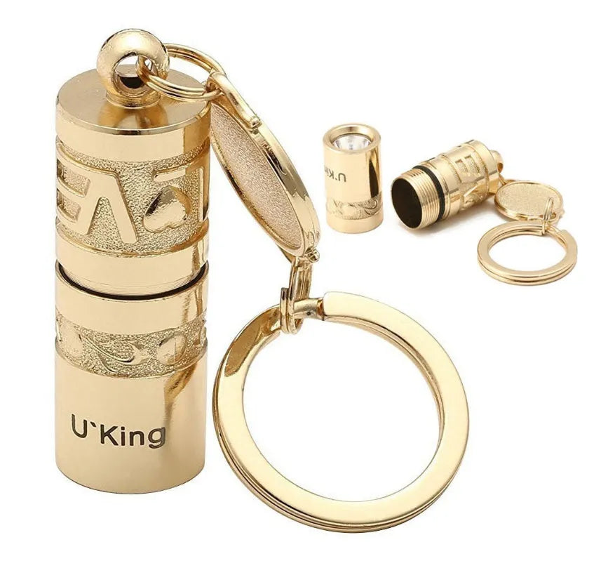 Gold-coloured zinc alloy waterproof mini LED flashlight on a keychain ring.