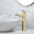 Square handle brushed gold pull faucet with brass construction on a sink.