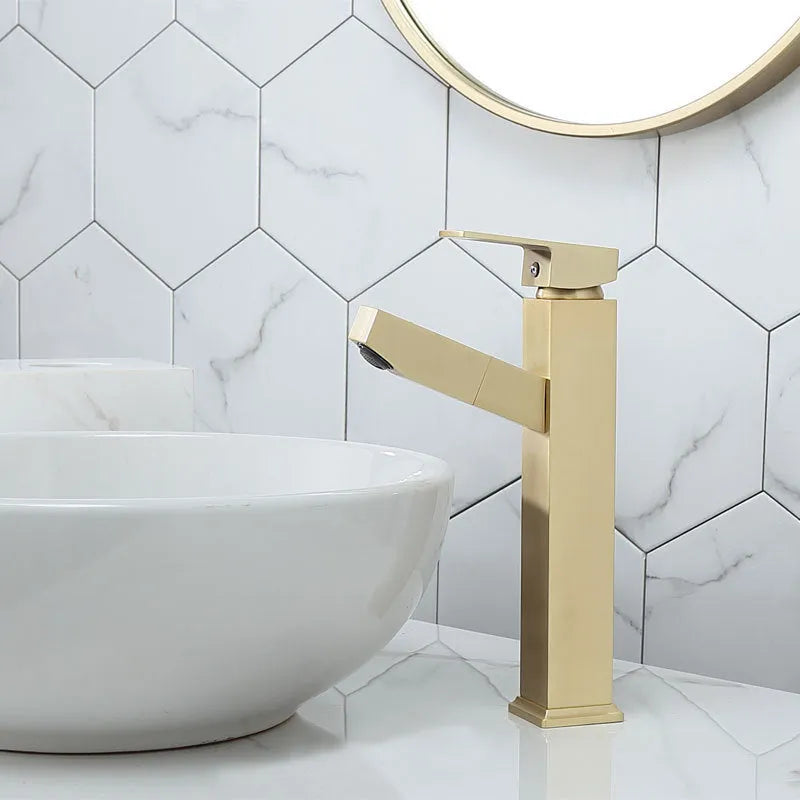 Square handle brushed gold pull faucet with brass construction on a sink.