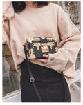Women's hard-sided black PU leather flap shoulder bag with rivet decoration and hasp closure