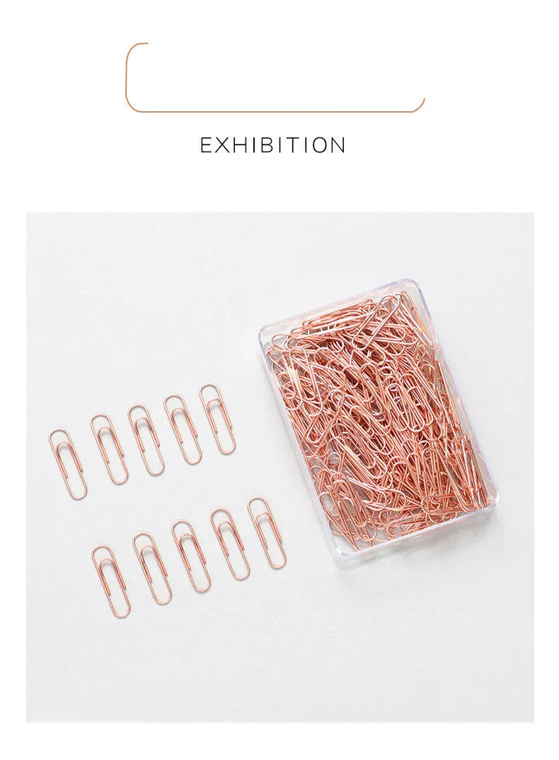 Rose gold coloured metal heart-shaped paper clips, size 28mm, in a box of 100 pieces.