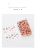 Rose gold coloured metal heart-shaped paper clips, size 28mm, in a box of 100 pieces.