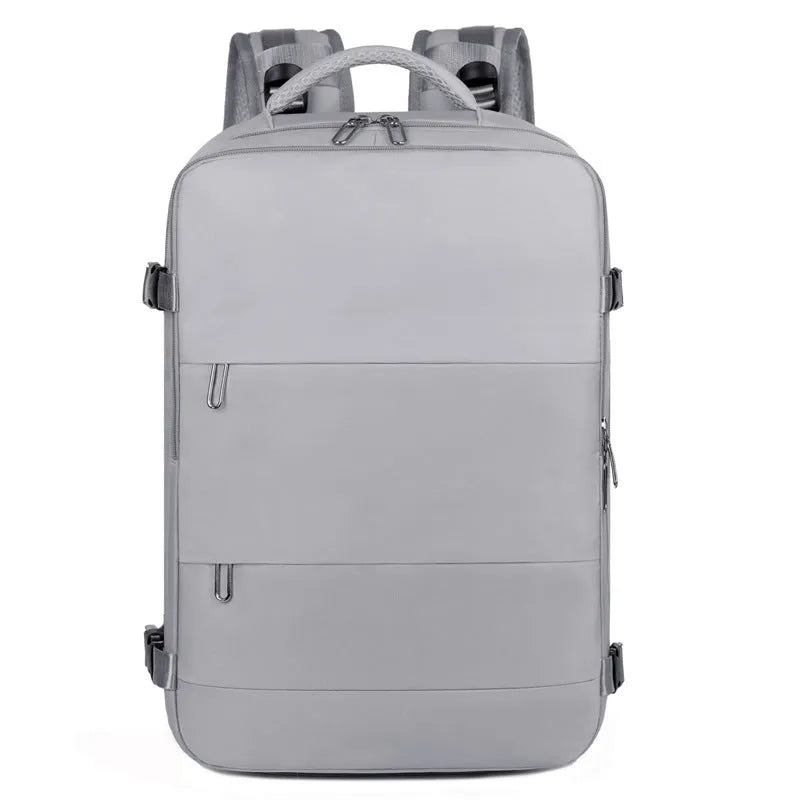 Large grey travel backpack for women with multiple compartments, shown open.