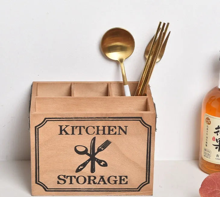 Open wooden kitchen storage box with grid divider for knives, forks, and chopsticks.