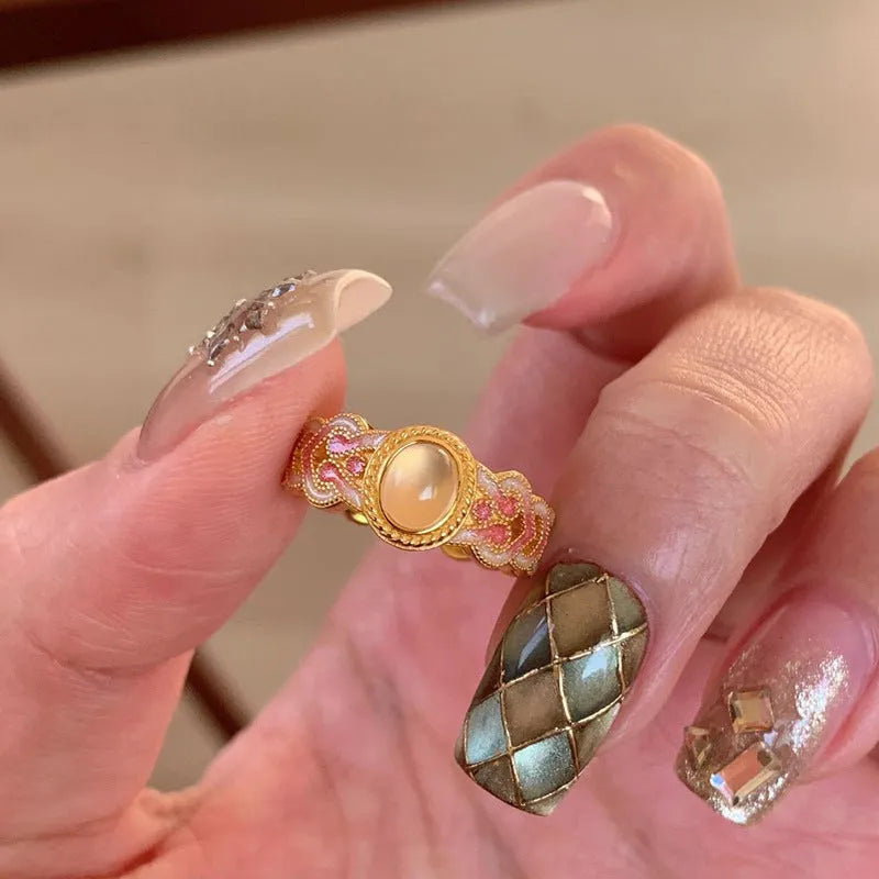 Geometric open-mouth ring with pink crystal enamel decoration on gold-plated copper band