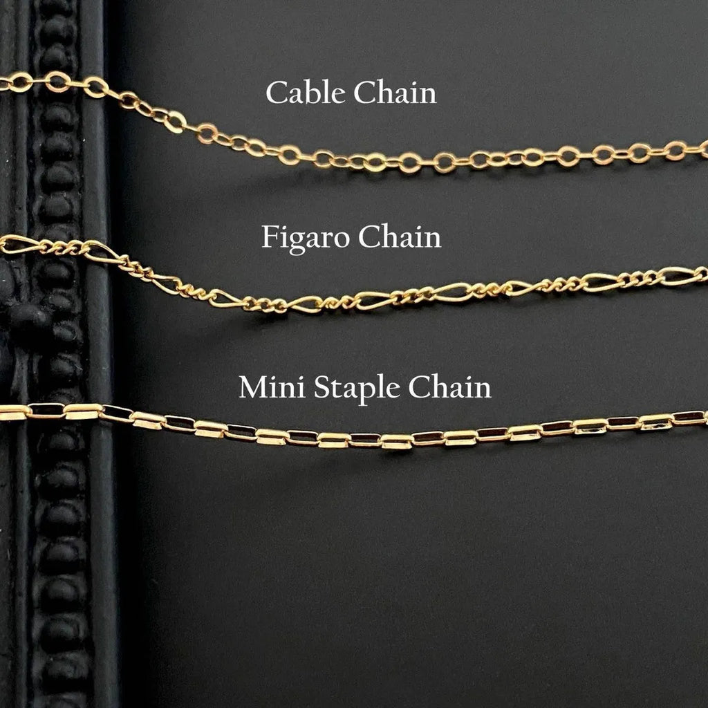 Ghost pendant necklace on a twisted stainless steel chain, shown in Cable, Figaro, and Mini Staple style options.
