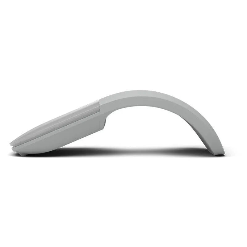 Black folding Bluetooth wireless mouse shown both folded and unfolded beside laptop