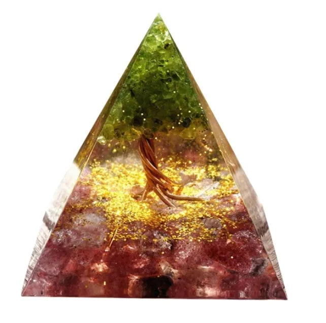 Clear epoxy resin pyramid ornament with natural crystal gravel inside on a wooden surface.