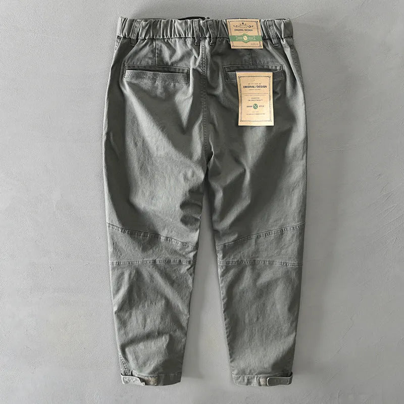 Man wearing khaki-coloured casual cotton overalls with a loose fit and mid-waist design.