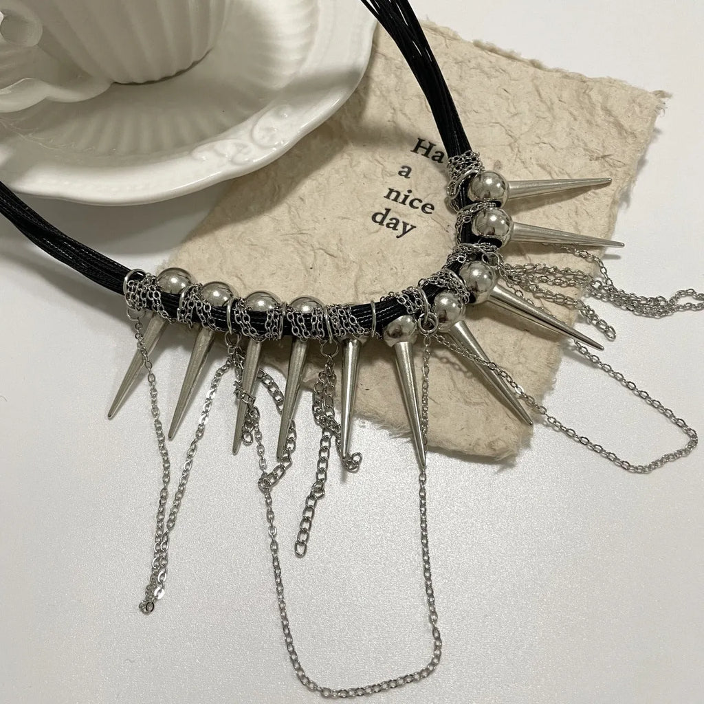 Leather necklace with round beads, a winding tassel, and point rivets in an electroplated picture colour.
