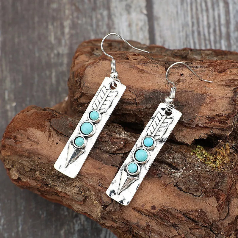 Silver geometric earrings with turquoise inlay in long strip design