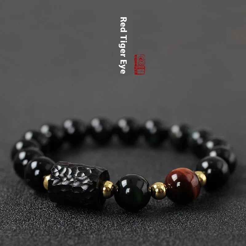 Obsidian bracelet with 10mm yellow tiger eye beads showing manual processing details and retro circle style