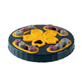 Blue interactive dog slow feeder puzzle toy with multiple food compartments on textured base