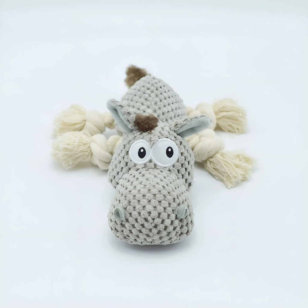Grey plush donkey dog toy with creaking sound, showing size against a hand.