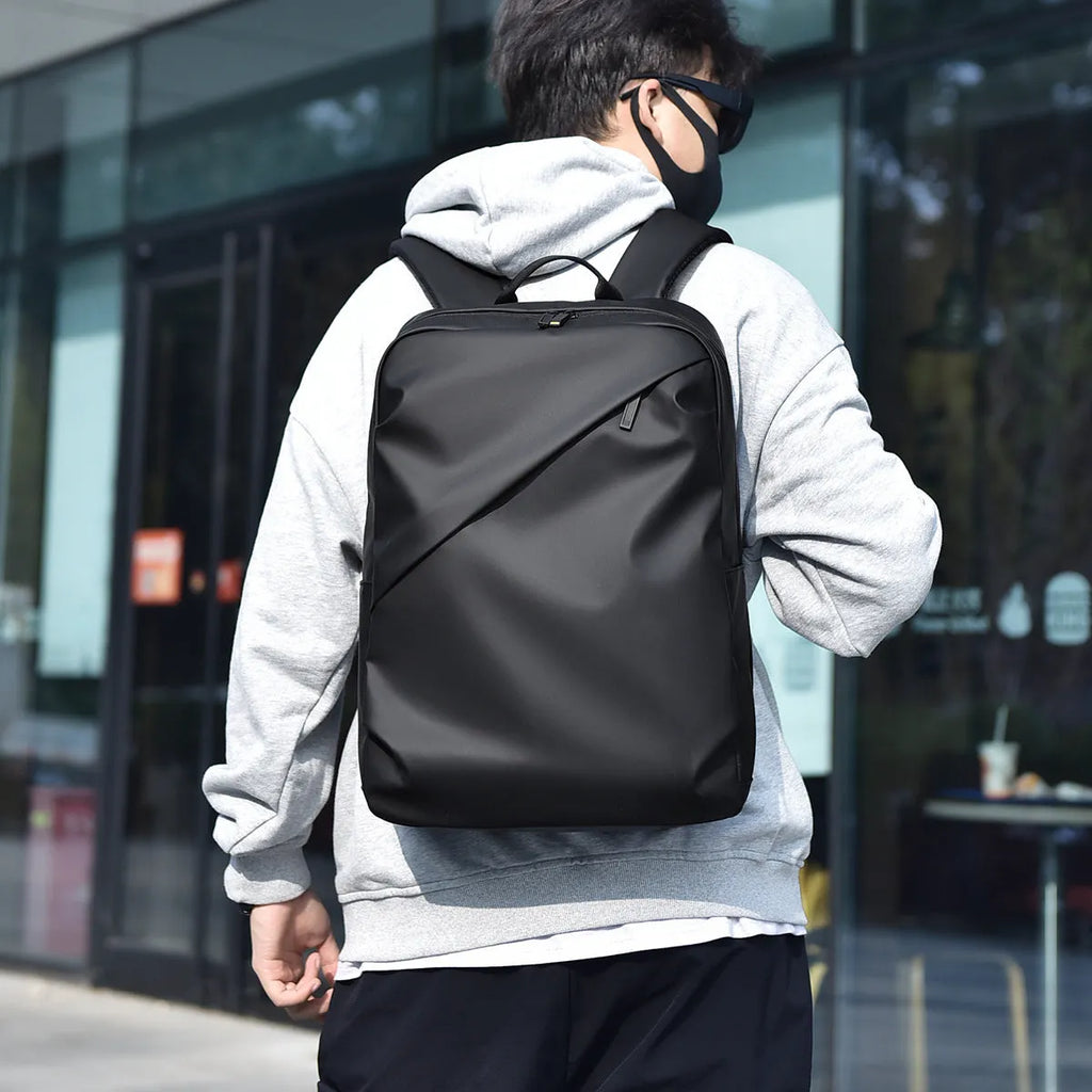 Men's waterproof backpack in black, blue or grey colour with PU leather construction and sewing thread detailing