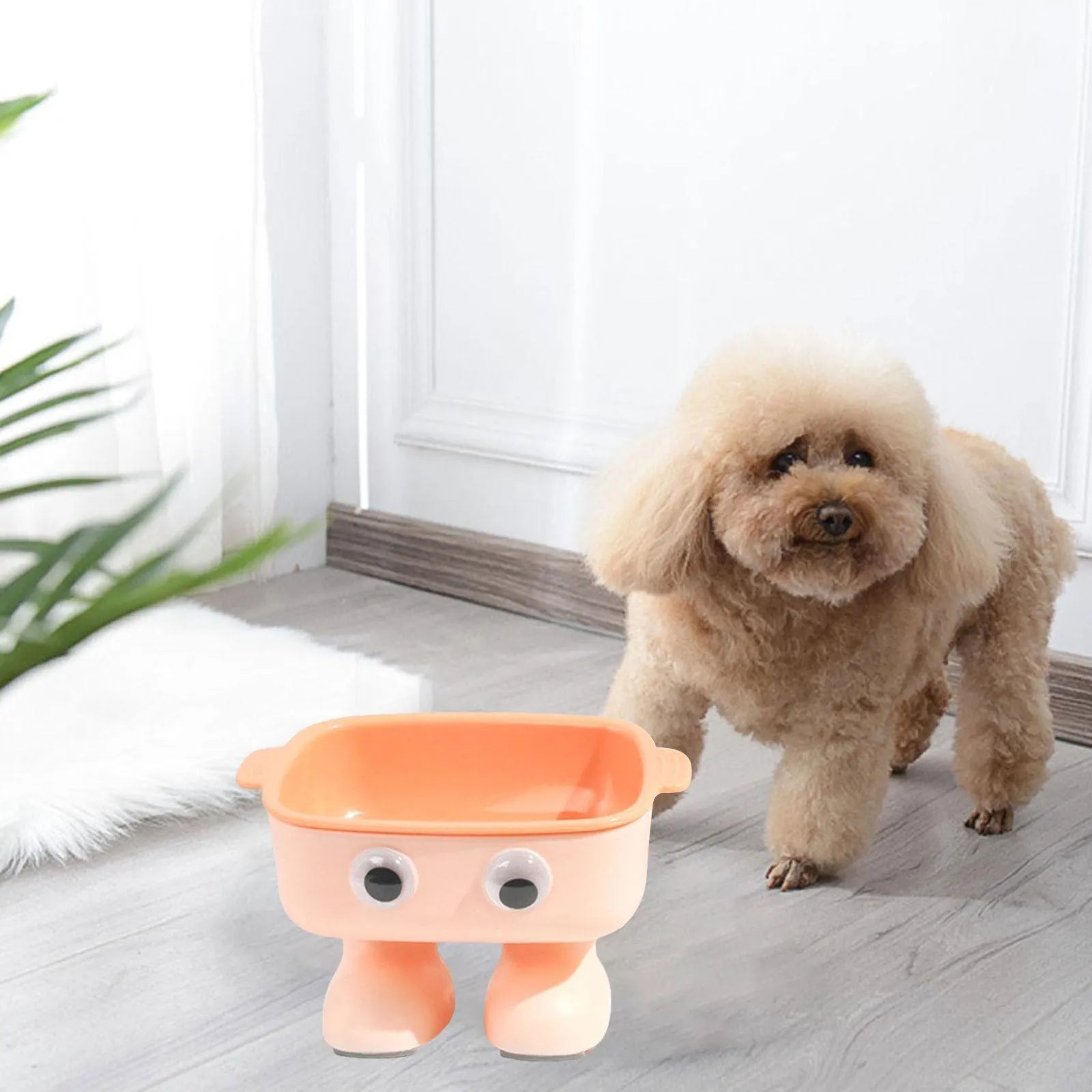 Green robot-shaped elevated cat bowl with tilted design and removable inner bowl on anti-slip base