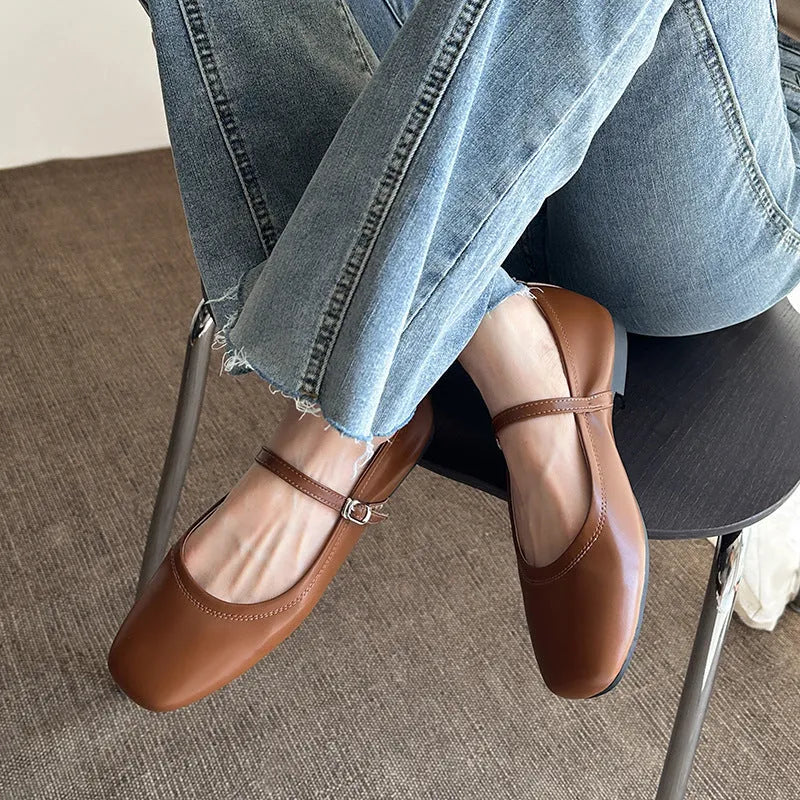 Women's retro black sheepskin Mary Jane flat shoes with a round toe and ankle strap on a rubber sole.
