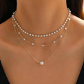 Three-layer gold imitation pearl necklace with twin pendant leaf U-shaped geometric design