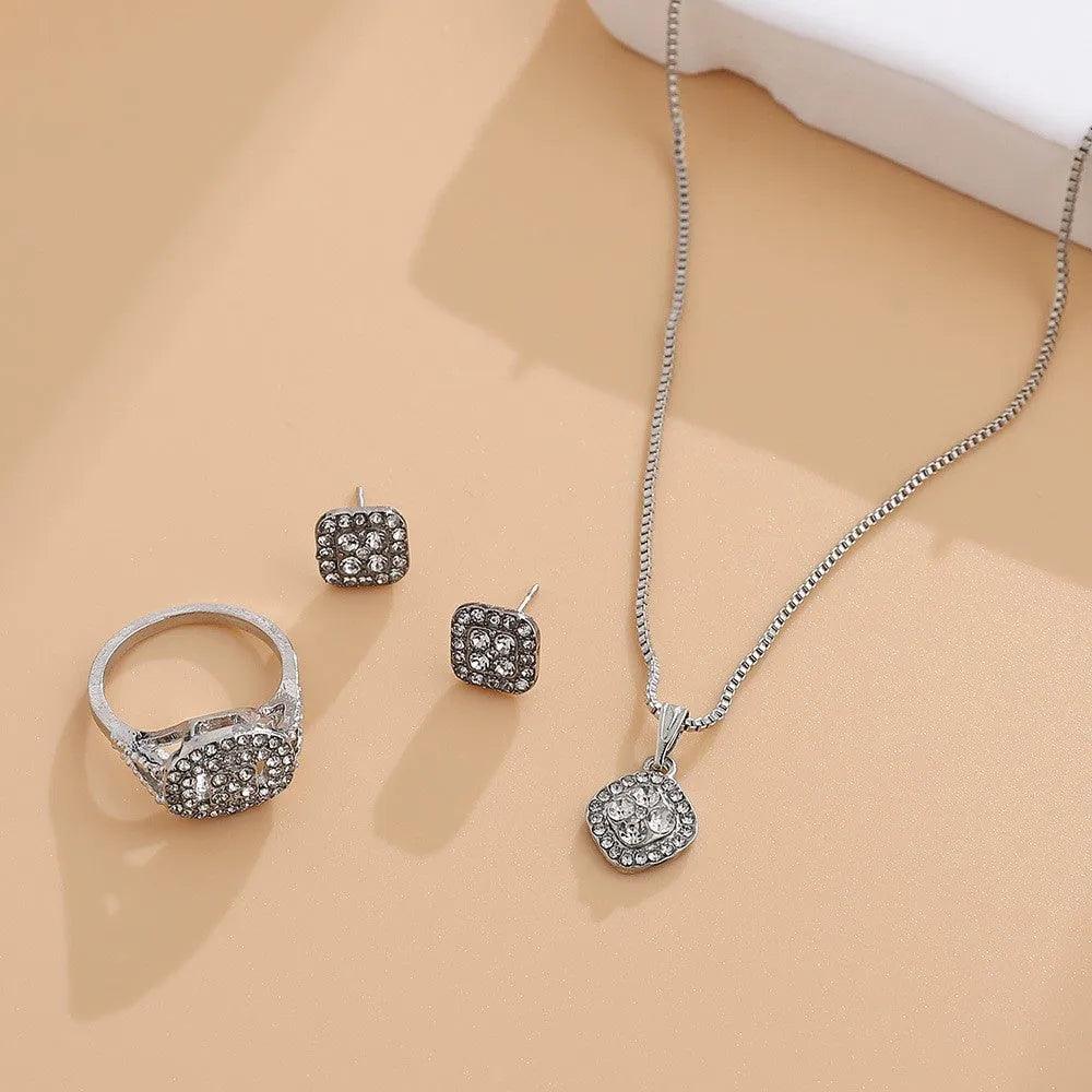 Three-piece alloy rhinestone wedding jewellery set with ring, stud earrings, and necklace in gold finish