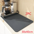 Black super absorbent square rubber drain pad mat on a kitchen countertop