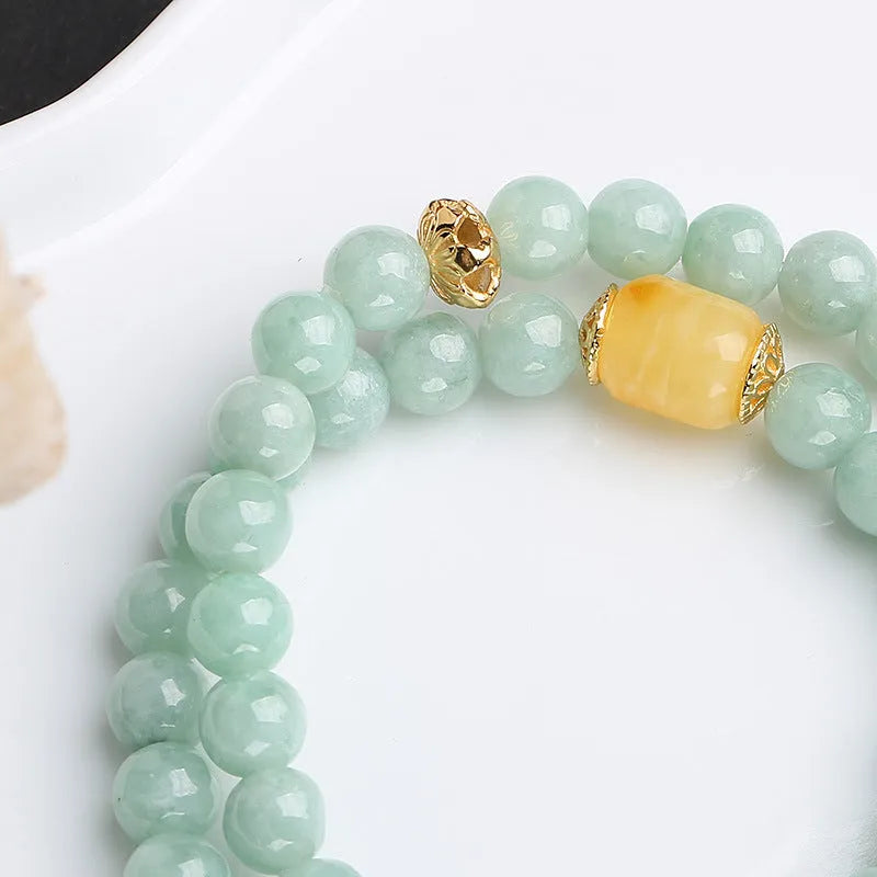Close-up of a double-layer women's bracelet with jade round beads and beeswax barrel beads in a retro geometric design